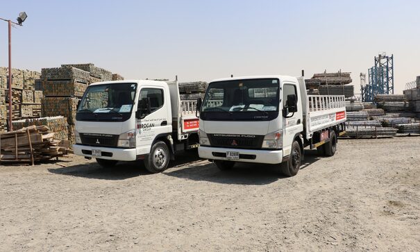 two trucks side by side in saudi yard
