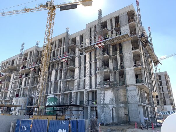 construction site building with mast climbers along the side